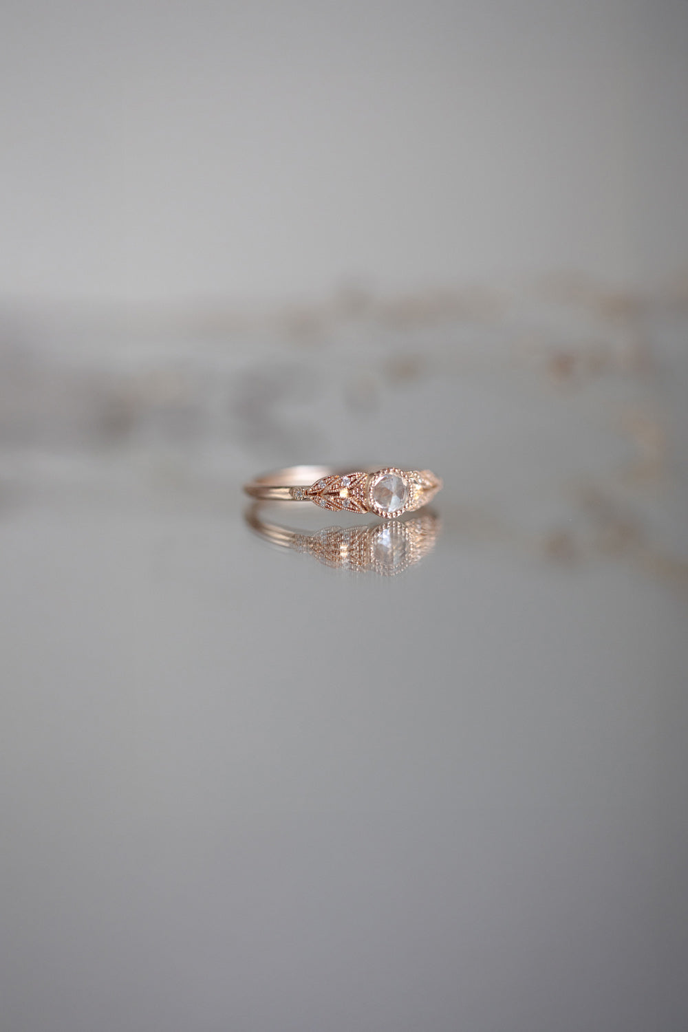 Designer engagement ring in gold with rose-cut white sapphire by Myrtille Beck