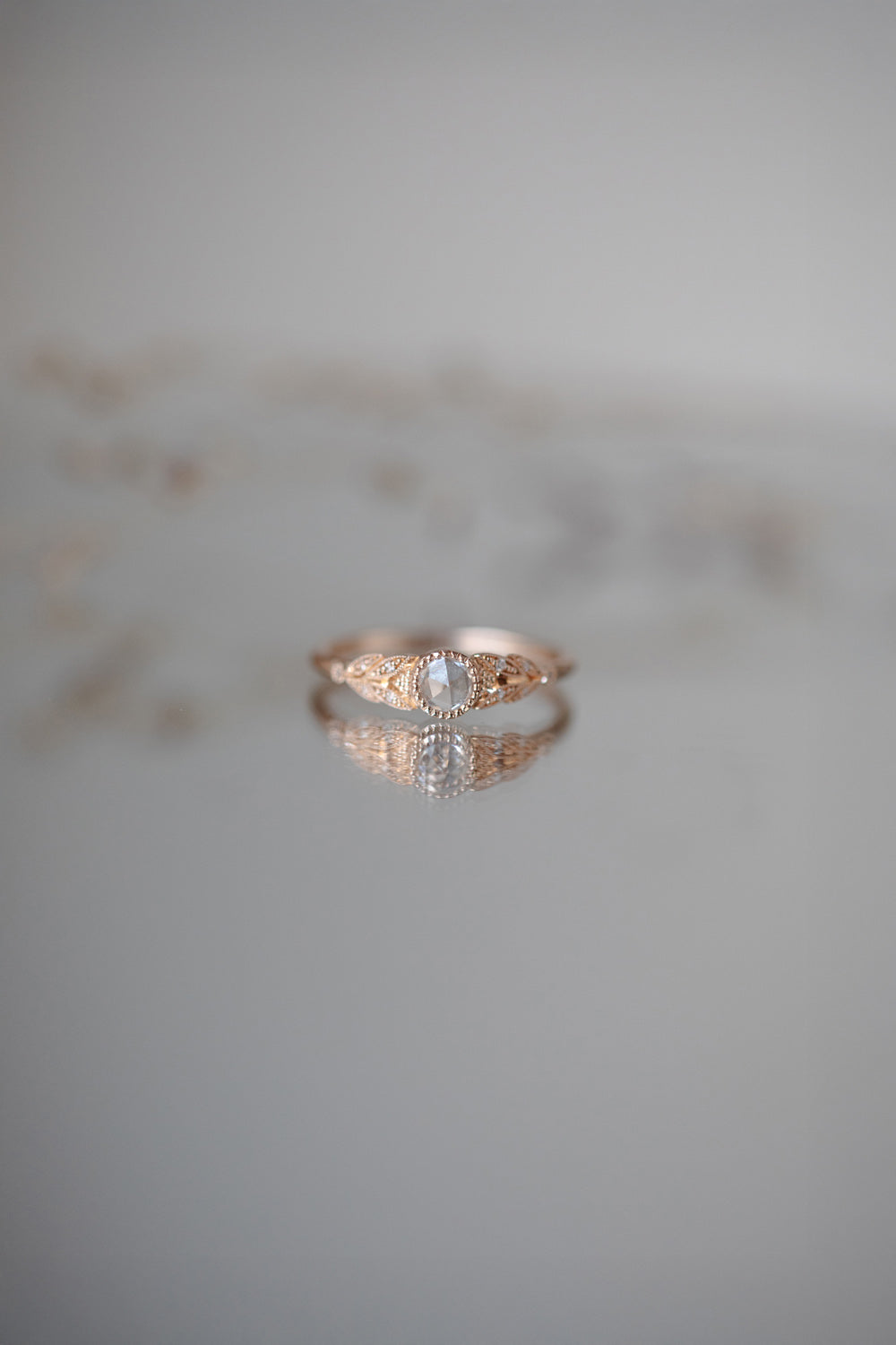 Designer engagement ring in gold with rose-cut white sapphire by Myrtille Beck