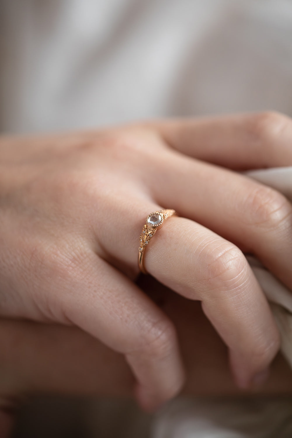 Designer engagement ring in gold with rose-cut white sapphire by Myrtille Beck